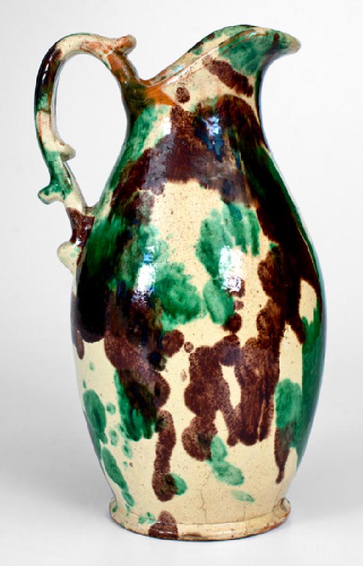 Shenandoah Valley (Strasburg, VA) Multi-Glazed Redware: Shenandoah Valley Multi-Glazed Redware Washbowl Pitcher, attributed to J. Eberly & Co., Strasburg, VA, circa 1890, ovoid pitcher with footed base, upswept spout, and ribbed strap handle with applied t