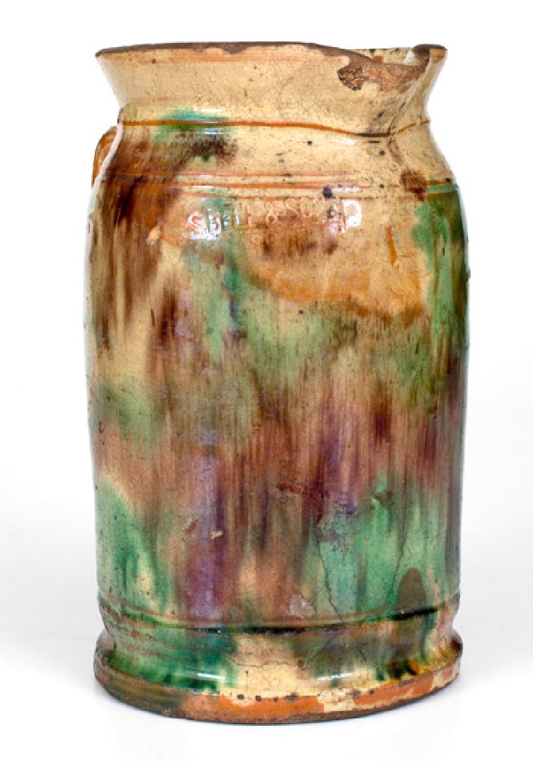 S. BELL & SON / STRASBURG, VA Multi-Glazed Redware: Shenandoah Valley Multi-Glazed Redware Tankard Pitcher, Stamped "S. BELL & SON / STRASBURG", VA origin, circa 1890, cylindrical pitcher with footed base, tooled shoulder, and flared rim, the surface d