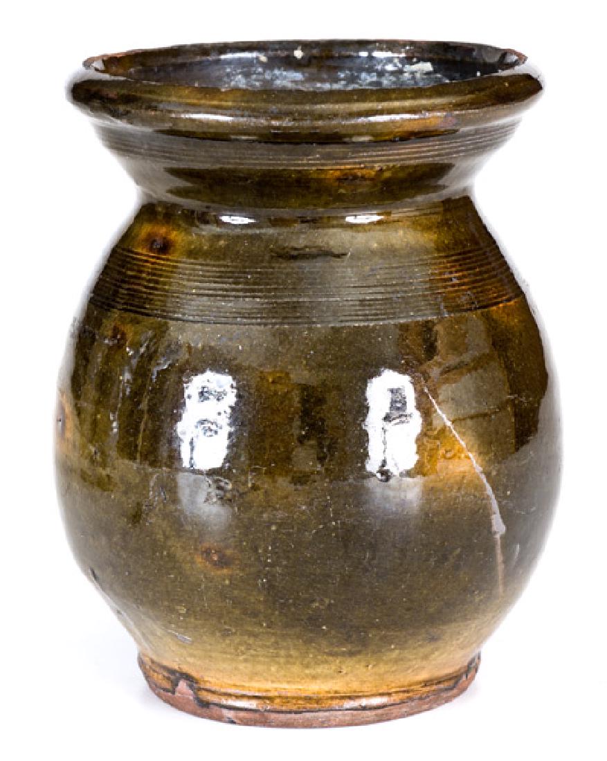 Bulbous New England Redware Jar: Glazed Redware Jar, New England origin, early 19th century, finely-potted, ovoid jar with footed base and flared rim, decorated with incised combing to the rim and shoulder, the lead-glazed surface wi