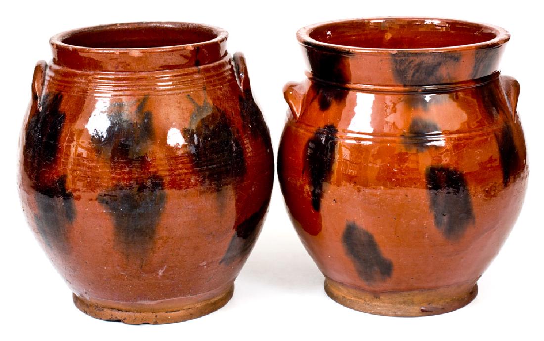 Lot of Two: Norwalk, Connecticut Redware Jars with: Two Glazed Redware Jars, Norwalk, CT origin, circa 1840, both of ovoid form with applied handles, daubed manganese decoration, and clear lead glaze. High-collared example with wear to one handle, smal