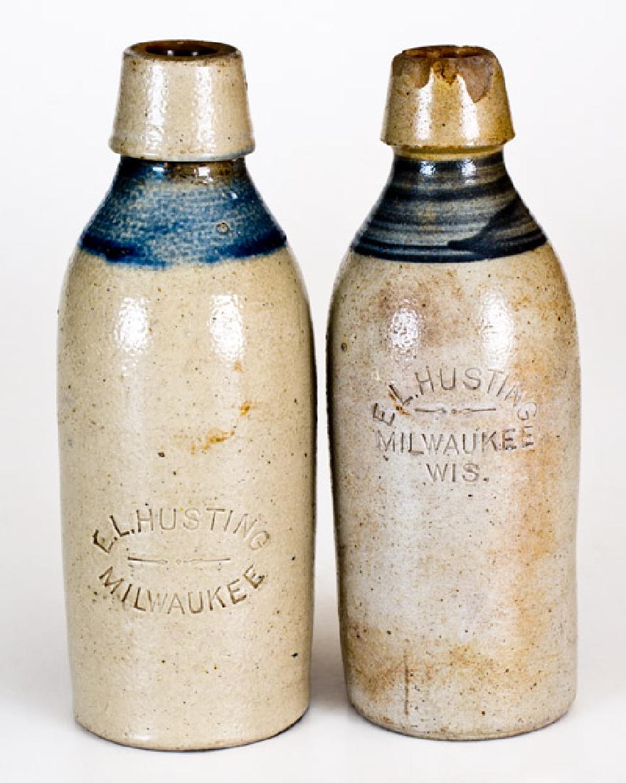 Lot of 2: E.L. HUSTING / MILWAUKEE, WIS. Stoneware: Two Cobalt-Decorated Wisconsin Stoneware Bottles, Stamped "E.L. HUSTING / MILWAUKEE", circa 1877-1900, both of cylindrical form with pronounced spouts and cobalt-banded shoulder, each bearing a differ