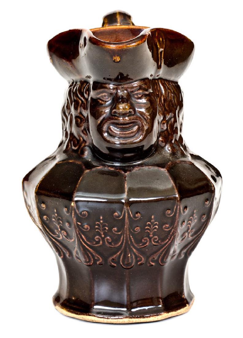 Small-Sized AMERICAN POTTERY Co. / JERSEY CITY, N.J.: Small-Sized Stoneware Toby Pitcher, Stamped "AMERICAN POTTERY Co. / JERSEY CITY, N.J.", circa 1845, molded pitcher with spout in the form of a man's face with tricorn hat, foliate decorated midsection