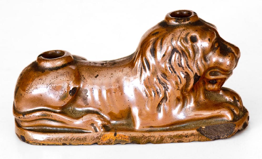 Exceptional Brown-Glazed Lion-Form Inkwell: Albany-Slip-Glazed Lion Inkwell, probably Northeastern U.S., Dated "Feb. 14, 1855", molded inkwell in the form of a reclining lion atop an oval base, with circular holes in the top of the head and hau