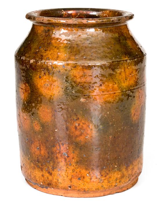 New England Glazed Redware Jar: Glazed Redware Jar, New England origin, second quarter 19th century, cylindrical form with tapered shoulder and flattened rim, the lead-glazed surface decorated with sponged manganese over a colorful