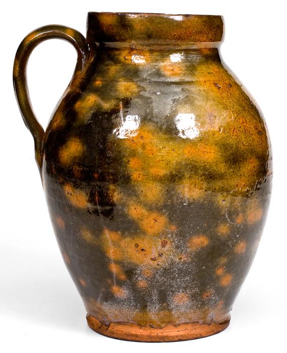 Unusual New England Handled Redware Jar: Fine Glazed Redware Handled Jar, New England origin, early 19th century, thin-walled, ovoid jar with footed base, semi-squared rim, and applied handle, the lead-glazed surface featuring brilliant dark