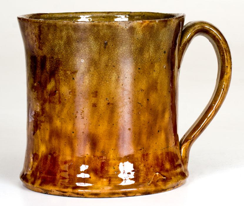 JOHN BELL (Waynesboro, PA) Redware Mug: Glazed Redware Mug, Stamped "JOHN BELL", Waynesboro, PA, circa 1840-1880, flared mug with footed base and applied strap handle, decorated with heavily-sponged manganese over a mottled green and orange
