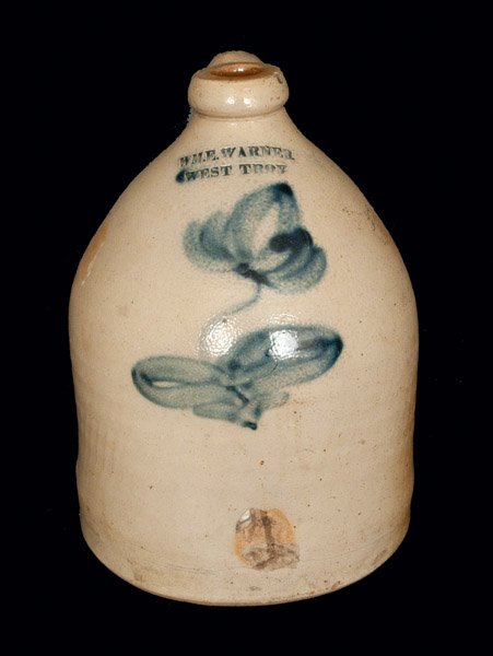 WM. E. WARNER / WEST TROY Stoneware Jug with Floral Dec: One-Gallon Cobalt-Decorated Stoneware Jug, Stamped "WM. E. WARNER / WEST TROY," New York State origin, circa 1850, decorated with a large brushed cobalt flower. In-the-firing flake and contact mark ne