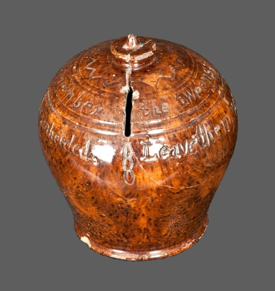 Dauphin County, Pennsylvania Redware Poem Bank, Incised: Very Rare Dauphin County, PA Redware Poem Bank, Signed "Made by / A.J. Bressler / 1873," ovoid bank with rounded foot, vertically-carved slot, and button-shaped finial with pointed tip. Shoulder embel