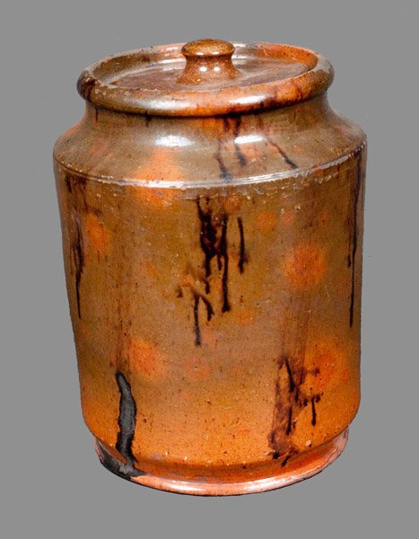Lead-Glazed Redware Jar with Manganese Decoration: Glazed Redware Jar with Lid, American, Pennsylvania or New England origin, 19th century, cylindrical jar with unusual inwardly-tapering base with rounded foot, the surface decorated with drips of mang