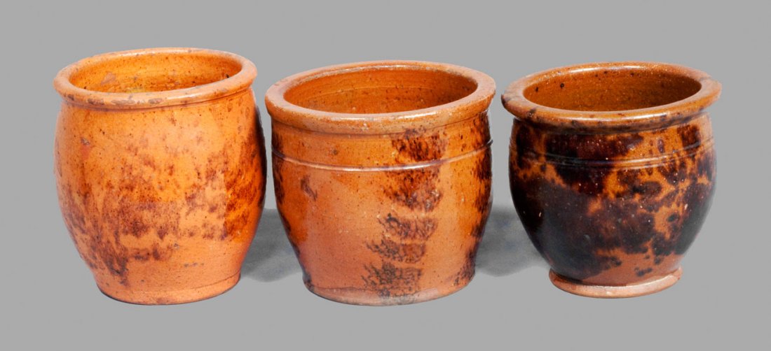 Lot of Three: Small PA Redware Cream Jars with Manganes: Three Glazed Redware Jars, Pennsylvania origin, second half 19th century, all of small size and similar form, one with vertical manganese sponging, and two with splashed manganese glaze. One additiona