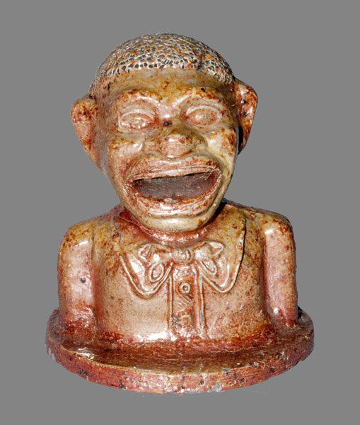Very Unusual Stoneware "Jolly N-----" Bank: Highly Unusual Stoneware Bank Depicting a Black Man's Torso, probably Midwestern origin, late 19th or early 20th Century, the bank converted from a popular mechanical bank of the period, with the man"