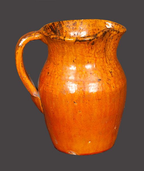 Pottery Cream Pitcher with Incised House Signature, Log: Glazed Pottery Cream Pitcher, Log Cabin Pottery, Guilford County, NC, circa 1926-1933, ovoid pitcher with tooled midsection, flared rim, and ribbed strap handle, the surface covered in a streaky reddi