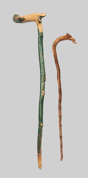 Two Carved Canes with Deer Handles, American, late 19th: Two Carved Canes with Deer Handles, American, late 19th century, one with handle carved in the form of a stylized stag's head with antler; the other with old green-painted surface and handle carved in