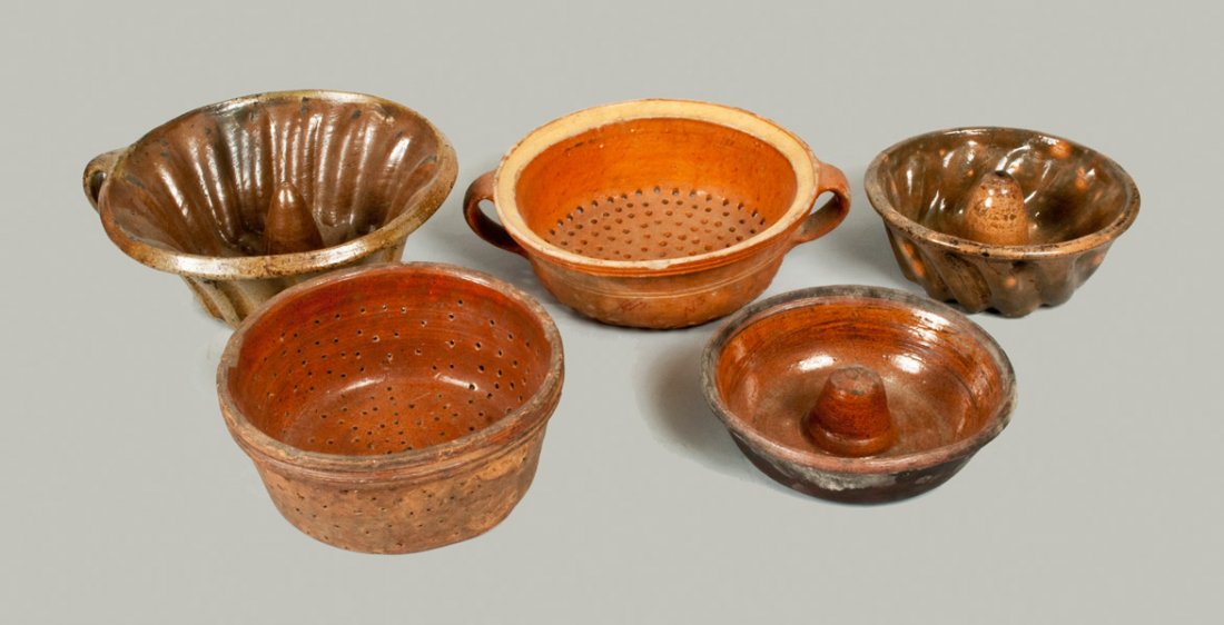 Five Utilitarian Pottery Cooking Articles, 19th century: Five Utilitarian Pottery Cooking Articles, 19th century, a salt-glazed stoneware food mold with handle; an open-handled redware collander with lead-glazed surface and yellow slip band on interior; a r