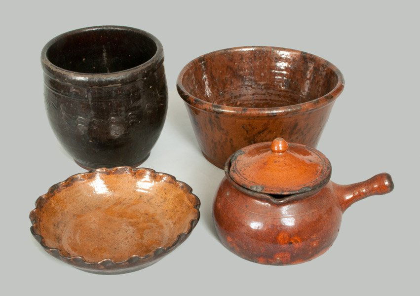 Four Utilitarian Redware Articles, American, 19th centu: Four Utilitarian Redware Articles, American, 19th century, an unusual lidded redware pipkin with rounded handle; lead-and-manganese glazed redware pan, PA origin; a black-glazed redware with heavily-t