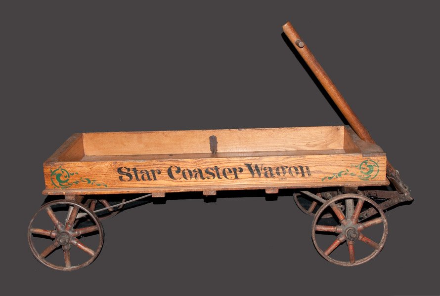 Wooden Star Coaster Wagon, late 19th or early 20th Cent: Wooden Star Coaster Wagon, late 19th or early 20th Century, with cast iron wheels, wooden spokes, and cast iron hand break at rear, stenciled "STAR COASTER WAGON" in black, flanked by green scrolled s