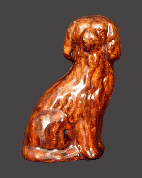 Miniature Redware Spaniel att. John Bell, Waynesboro,: Scarce Miniature Glazed Redware Figure of a Spaniel, attributed to John Bell, Waynesboro, PA, circa 1840-1880, molded figure of a seated spaniel with hollowed underside, the surface covered in a strea