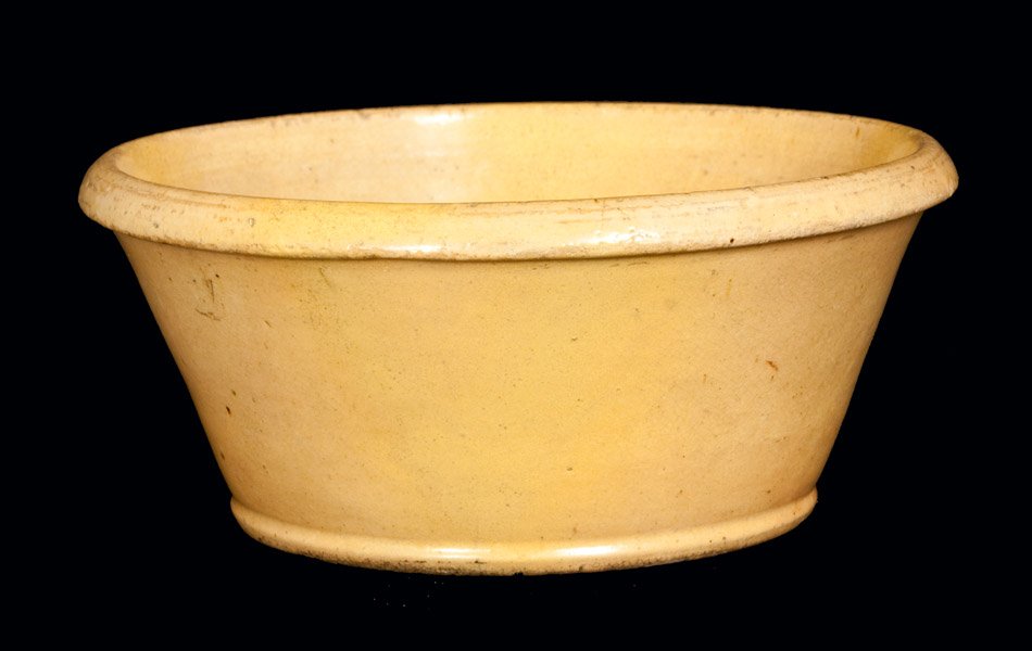Unusual Small JOHN BELL Yellow-Glazed Redware Bowl: Scarce Glazed Redware Bowl, Stamped "JOHN BELL," Waynesboro, PA, circa 1840-1880, tapered bowl with footed base, recessed underside, and angled rim molding, the surface covered in a lead glaze over a