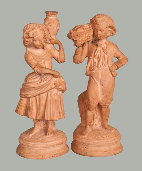 Pair of Redware Statues attrib. Hummelstown (PA) Terra: Pair of Redware Figures, attributed to the Hummelstown Terra Cotta Works, Pennsylvania origin, circa 1920, molded figures of a boy holding a fruit basket and girl holding a water urn, both in fine per