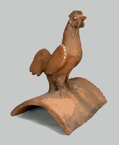 Terracotta Rooster Roof Tile: Large-Sized Terracotta Rooster Roof Tile, 20th century, large, hand-modeled rooster with incised details, seated atop an arched tile with china pieces accenting the rooster's wing and eyes. Chip to co