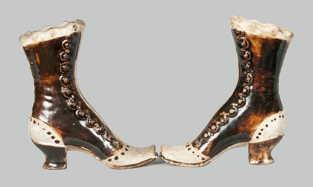 Unusual Pair of Tanware Boots: Rare Pair of Tanware Boots, Western PA or Ohio origin, late 19th century, pair of molded high-heeled boots with raised buttons, scalloped rims, and hollow interiors. Surfaces covered in cream-colored