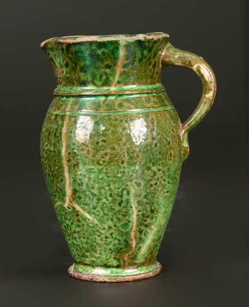 Shenandoah Valley Redware Creamer with Bright Copper: Very Rare Shenandoah Valley Redware Cream Pitcher with Solid Green Glaze, Strasburg, VA origin, late 19th century, finely-potted pitcher with ovoid body, narrow base with foot, and flared collar, the