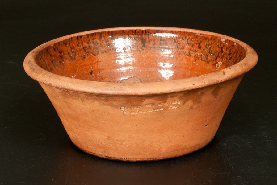 JOHN W. BELL / WAYNESBORO, PA Redware Bowl with: Redware Bowl with Manganese-Decorated Interior, Stamped "JOHN W. BELL / WAYNESBORO, PA," circa 1880, tapered bowl with semi-rounded rim, the interior shoulder decorated with manganese sponging, the su