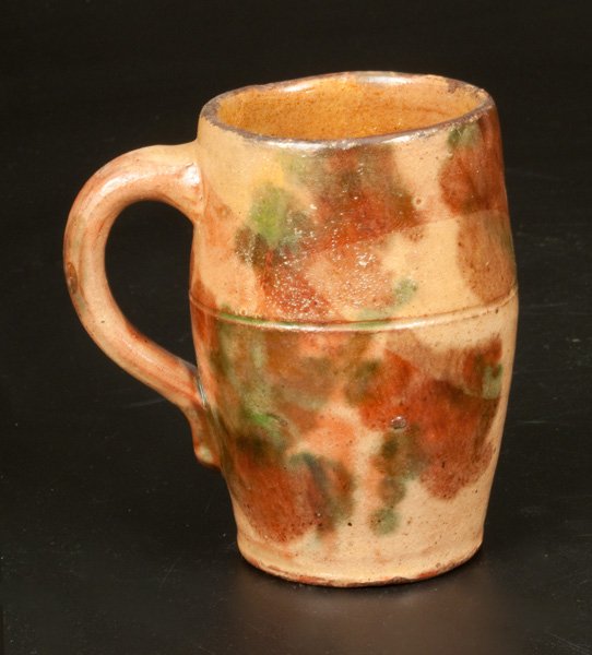 Shenandoah Valley Multi-Glazed Redware Mug: Shenandoah Valley Multi-Glazed Redware Mug, attributed to S. Bell & Son or J. Eberly & Co., Strasburg, VA, late 19th century, barrel-form mug with tooled line at midsection and applied handle, the sur