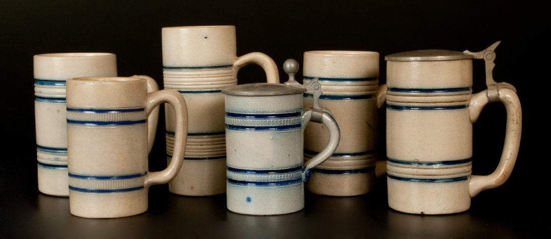 Lot of Six: Stoneware Banded Mugs att. Whites Utica: Six Cobalt-Banded Stoneware Mugs, attributed to the White's Pottery, Utica, NY, late 19th century, all of similar cylindrical form with tooled and cobalt-highlighted banding. Two with pewter lid, incl