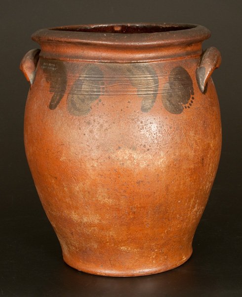 JOHN BELL / WAYNESBORO Ovoid Redware Jar with Brushed: Three-Gallon Redware Jar with Manganese Tulip Decoration, Stamped "JOHN BELL / WAYNESBORO," PA origin, third quarter 19th century, ovoid jar with incised shoulder, coved rim molding, and ribbed lug ha