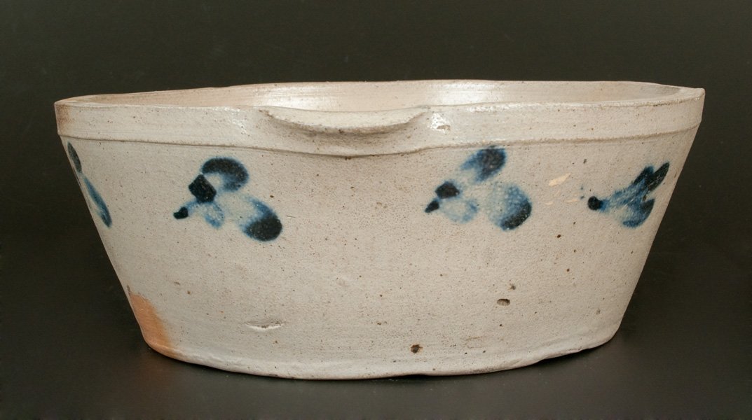 Baltimore Stoneware Milkpan circa 1880: One-Gallon Cobalt-Decorated Stoneware Milkpan, Baltimore, MD origin, circa 1880, tapered pan with pouring spout, decorated around the body with several brushed cobalt leaves or clovers. Rim chips. Two