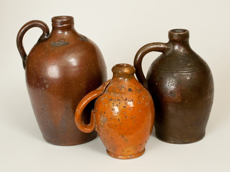 Lot of Three: Stoneware and Redware Jugs with Tennessee: Group of Three Stoneware and Redware Jugs, possibly Tennessee, 19th century, a miniature, lead-glazed redware jug with tooled shoulder and ribbed handle, probably Great Road, Tennessee origin; a quart