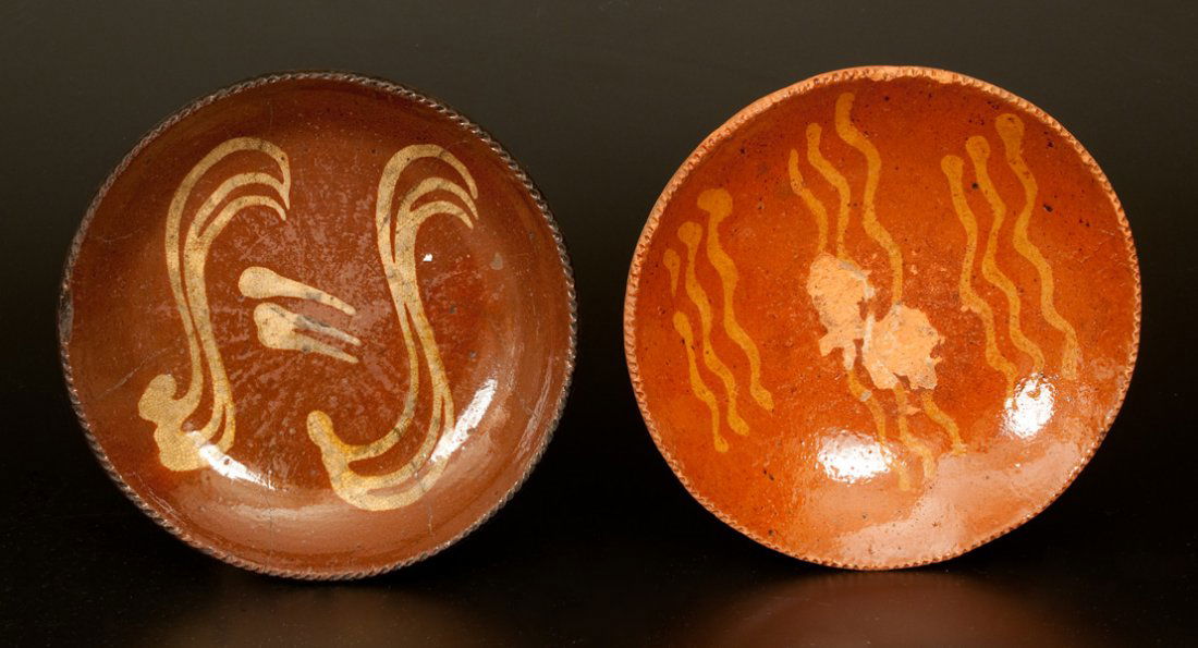 Lot of Two: Redware Plates with Yellow Slip Decoration: Two Slip-Decorated Redware Plates, American, 19th century, with coggled edge, both with wavy slip line decoration. Larger plate with heavy flaking to interior and wear to rim. Other plate with several