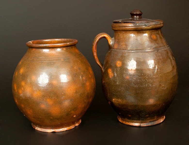 Lot of Two: Early Ovoid Redware Jars, New England: Two Pieces of New England Redware, first half 19th century, a handled jar with tooled shoulder and rim, paired with an ovoid jar with tooled shoulder, the surface covered in a lead glaze over an olive