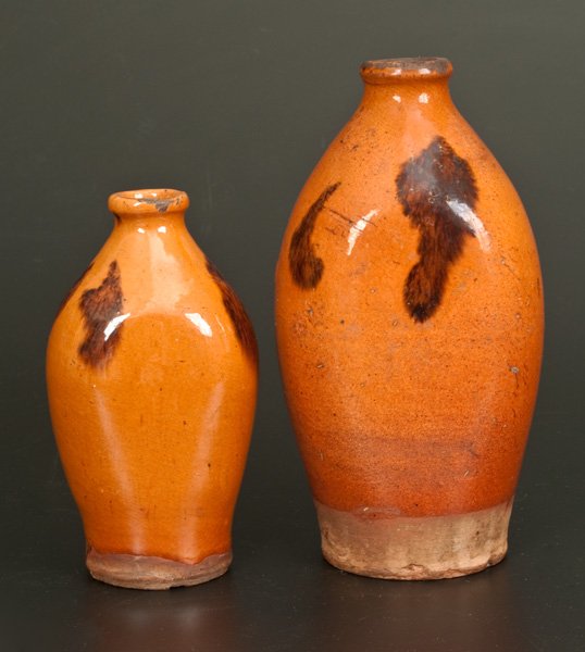 Lot of Two: Redware Flasks with Manganese Decoration: Two Glazed Redware Flasks, New England origin, first half 19th century, two similarly potted and glazed examples, with semi-rounded spouts and flattened sides, decorated with manganese daubs over a li
