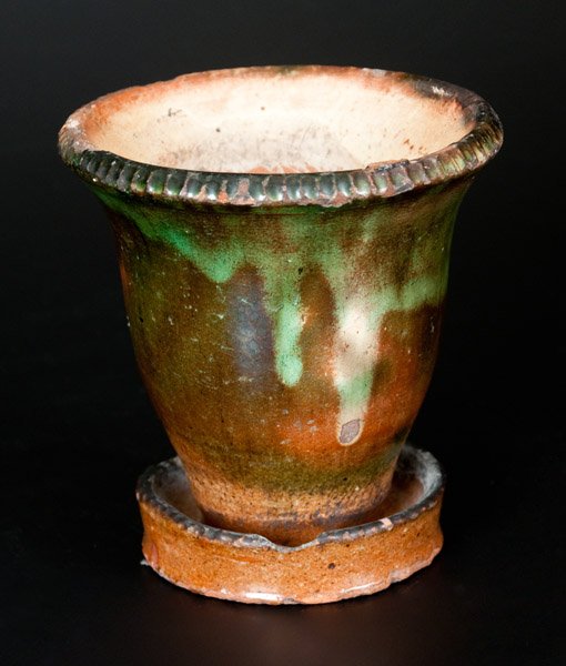 Small-Sized Shenandoah Valley Multi-Glazed Redware: Small-Sized Multi-Glazed Redware Flowerpot, attributed to S. Bell & Son, Strasburg, VA, late 19th century, ovoid flowerpot with flared rim and attached saucer, accented with coggled edges. Surface dec