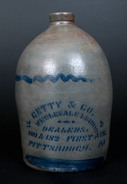 GETTY & CO. / PITTSBURGH, PA Stenciled Stoneware Liquor: One-Gallon Pittsburgh, PA Stoneware Advertising Jug, Western PA origin, circa 1875, ovoid jug with tooled spout, decorated with two freehand stripes and the stenciled cobalt advertising "GETTY & CO. /