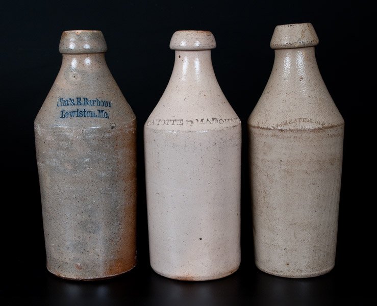 Lot of Three: Stoneware Bottles Impressed ROCHESTER,: Three Salt-Glazed Stoneware Bottles, Northeastern U.S. origin, second half 19th century, one impressed with the cobalt-highlighted advertising "Cha's. E. Barbour / Lewiston, Me."; one impressed "ROCHE