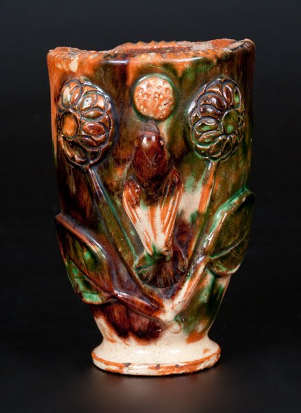 Shenandoah Valley Multi-Glazed Redware Wall Pocket,: Shenandoah Valley Multi-Glazed Redware Wall Pocket, Strasburg, VA origin, circa 1890, with footed base and coggled rim, the front decorated with an applied clay bird and floral design. Heavy impressed