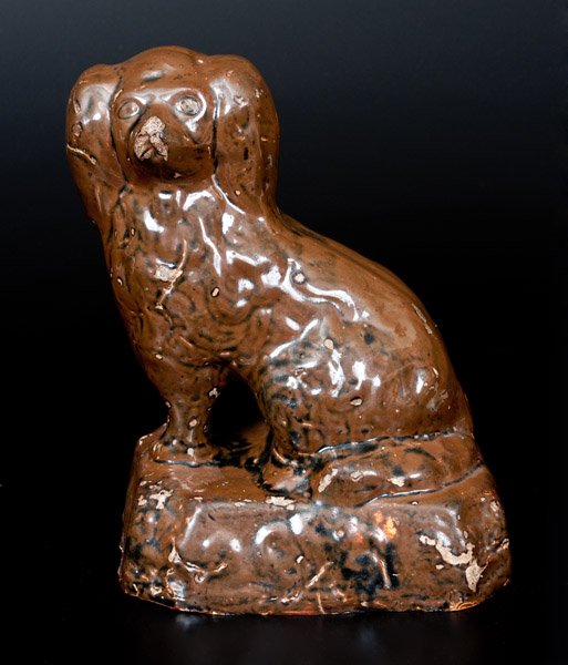 Albany-Glazed Stoneware Spaniel Inscribed "Tom Reid" on: Albany-Slip-Glazed Stoneware Spaniel, Inscribed "Tom Reid," probably Texas or Ohio origin, circa 1860-1890, molded figure of a seated spaniel on an octagonal base, the surface covered in a chocolate b