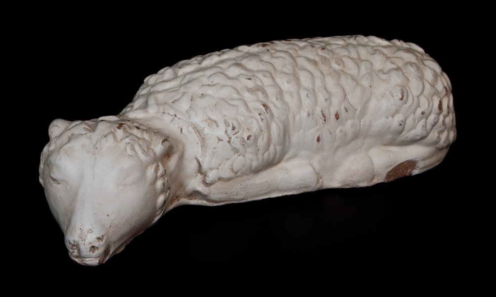 Rare Eberly, Strasburg, VA Painted Redware Lamb Figure: Rare Painted Redware Lamb Doorstop, attributed to J. Eberly & Co., Strasburg, VA, circa 1895, molded figure of a reclining lamb with closed eyes, the surface covered in white paint. Underrated in rari