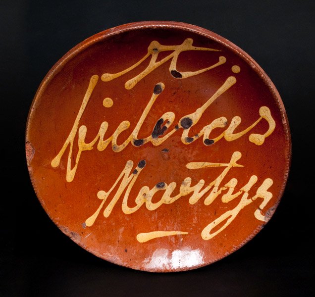 Norwalk, CT Redware Plate with Yellow Slip Inscription: Slip-Decorated Redware Plate, Inscribed "St. Fidelas Martyr," Norwalk, CT origin, mid 19th century, with coggled edge, the interior inscribed "St. Fidelas Martyr" in yellow slip script and covered in