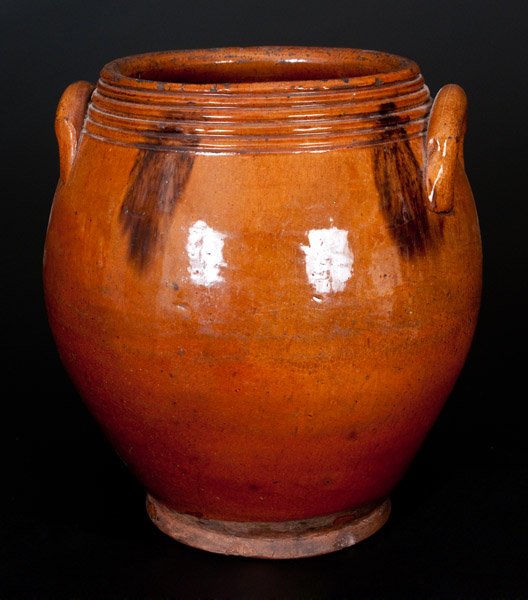 Unusual Glazed Redware Jar, probably Norwalk, CT or: Unusual Glazed Redware Jar, probably Norwalk, CT or Huntington, Long Island, New York, first half 19th century, ovoid jar with footed base, applied lug handles, and visually-appealing elaborate toolin