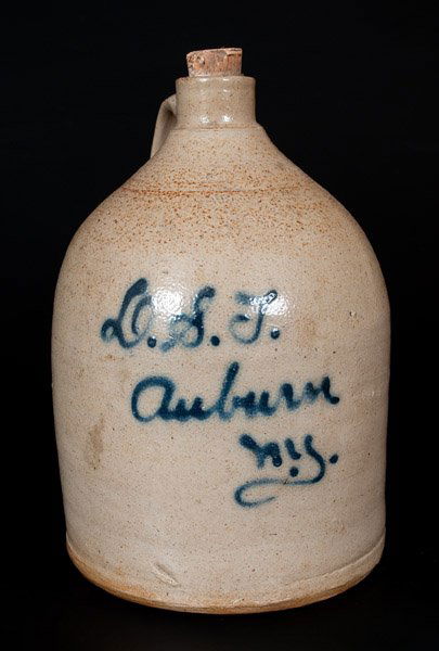 J. FISHER / LYONS, NY Stoneware Jug with Auburn, NY: One-Gallon Auburn, NY Stoneware Advertising Jug, Stamped "J. FISHER / LYONS, N.Y.," circa 1885, cylindrical jug with tooled shoulder and squared spout, featuring the slip-trailed inscription "O.S.T.,
