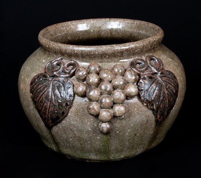 Rare Arie Meaders Stoneware Beanpot with Applied Grapes: Alkaline-Glazed Stoneware Beanpot with Applied Grapes Decoration, Incised on Underside "AM," Arie Meaders, White County, GA origin, third quarter 20th century, squat-shaped, ovoid form with flared rim