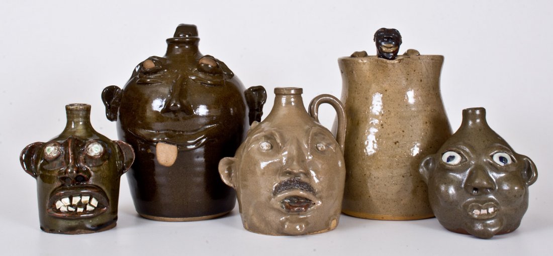 Five Southern Stoneware Face Vessels, late 20th or: Five Southern Face Vessels, late 20th or early 21st century, a small jug with three faces, incised "I'm schizophrenic and so am I", signed "Berry", Ned Berry, GA origin; a small face jug with cobalt e
