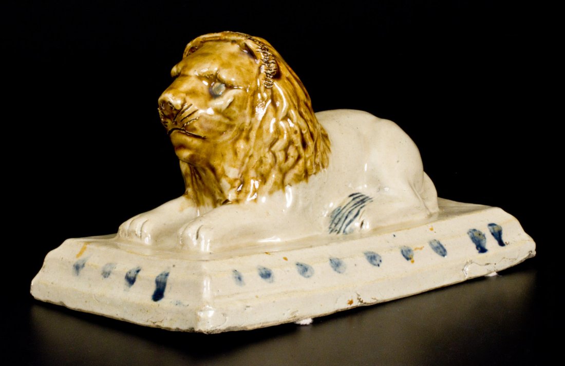 Outstanding Stoneware Lion attrib. A. P. Donaghho,: Outstanding and Very Rare Stoneware Lion Doorstop with Cobalt and Albany Slip Decoration, attributed to A.P. Donaghho, Parkersburg, WV, late 19th century, molded figure of a lion reclining atop a rect