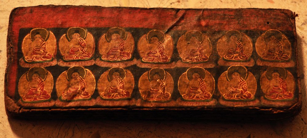 RARE MUSTANG BUDDHIST MANUSCRIPT, 15th century:  The Buddhist religious manuscript from the lost Kingdom of Mustang contains gold illuminated illustrations and script. The