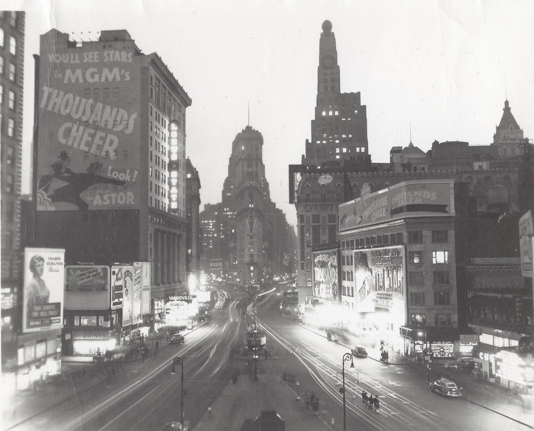 Attributed to Lou Stoumen, Times Square, ca. 1940.: Attributed to Lou Stoumen (1917-1991), A black and white snapshot view of Times Square with buildings, bustling traffic,and period billboards. Written in pencil on verso in unknown hand, "Photo by Lou