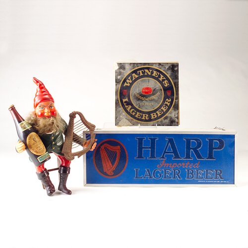 Three promotional beer items: Guiness plastic lepr: Three promotional beer items: Guiness plastic leprechaun with bottle and harp; WATNEY'S LAGER BEER sign; HARP IMPORTED LAGER BEER lighted sign, working. Tallest 19 1/2"